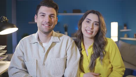 happy married couple talking to camera in a playful and funny way.