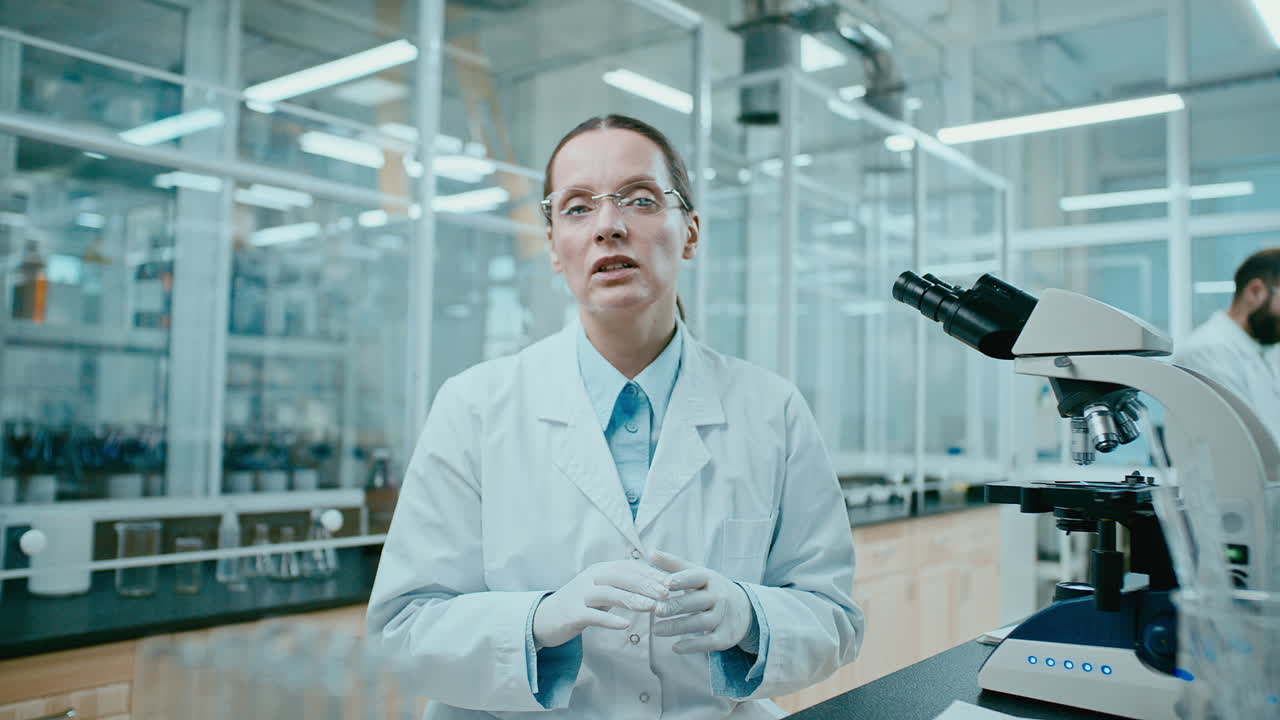 Female Scientist Explaining Research Findings to Camera in Laboratory
