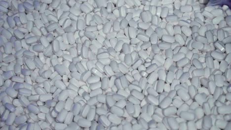 close-up view of a pile of pills being manufactured by a machine