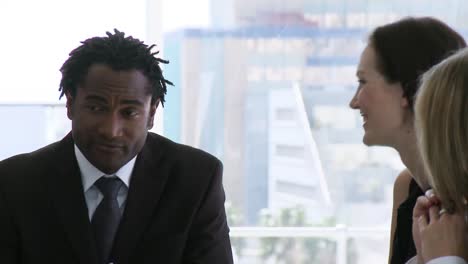 three business people talking in a business meeting