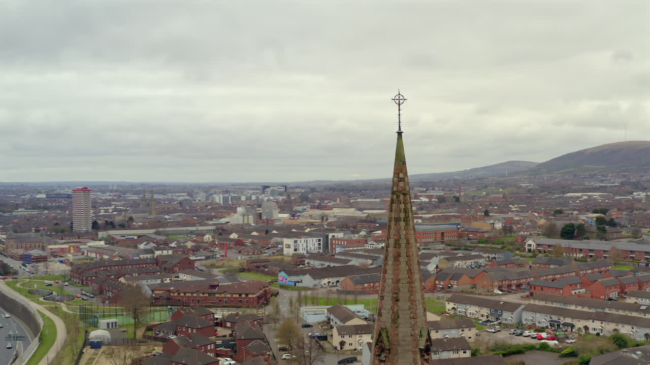 Carlisle Memorial Church aerial with traffic, cloudy sky and Belfast city in background, tower spire with cross
