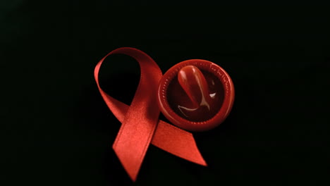 condom dropping down beside red ribbon