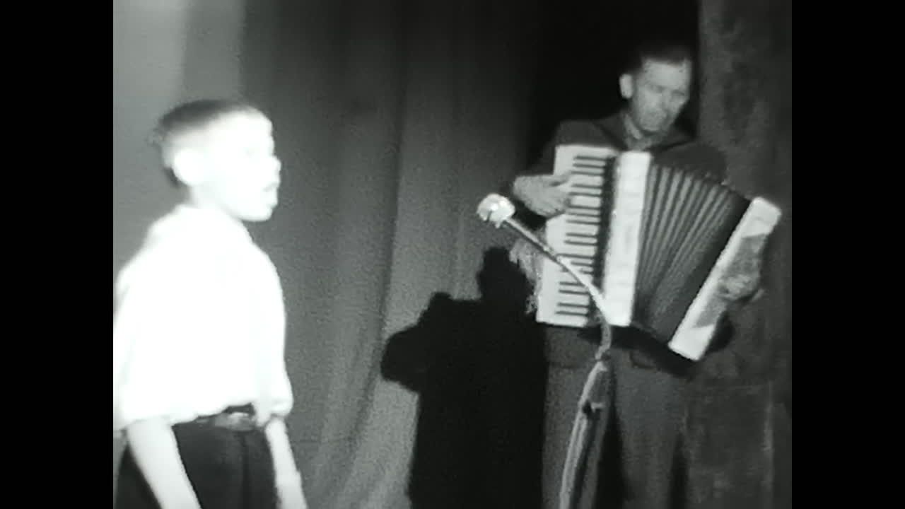 Black and White Video of Soviet children Playing an Stage. CIRCA USSR 1970: Black and White Video of Soviet children Playing an Stage