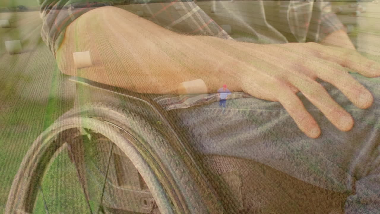 Person's hand resting on wheelchair armrest with grassy field animation overlay