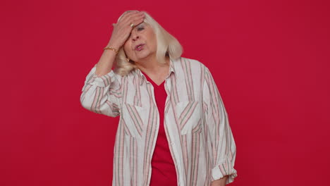 upset stylish senior woman making face palm gesture, feeling bored, disappointed in result, bad news