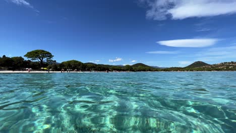 beautiful low angle sea water surface point of view of santa giulia beautiful beach in corsica island, france