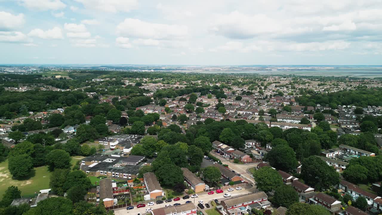 Topdown aerial establishing of Medway town with streets and interspersed green vegetation