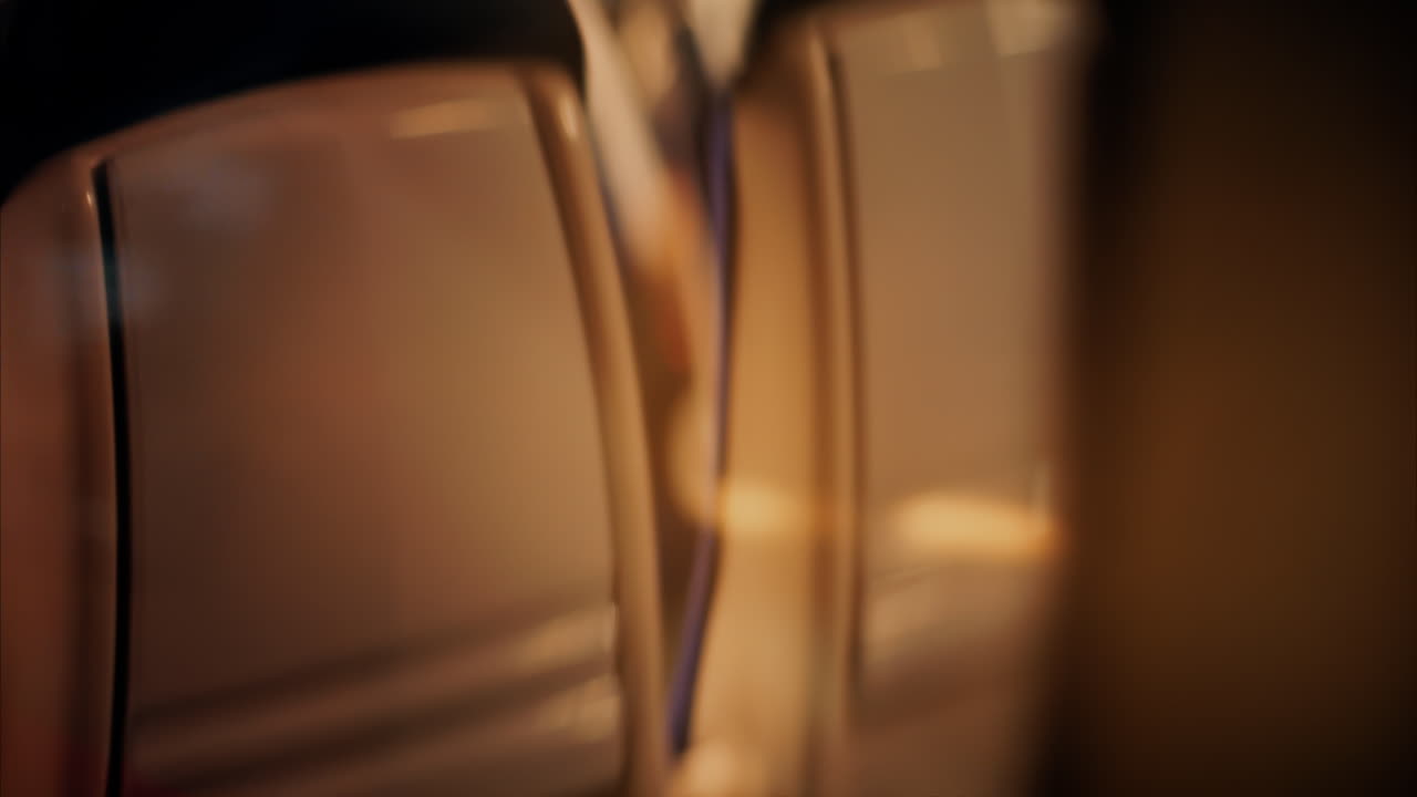 Close up of the window of a moving train with a blurry view