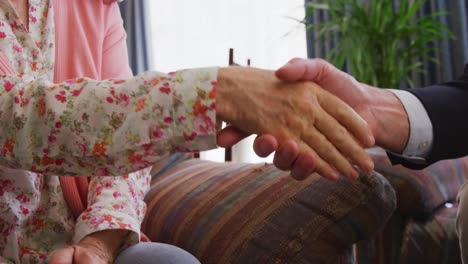 pareja de ancianos hablando con un hombre de negocios en una casa de jubilación