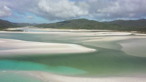 antenna lenta bassa dalla spiaggia dell'oceano sopra la laguna verde sabbiosa poco profonda