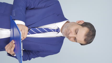 Vertical-video-of-Businessman-alerting-camera-with-stern-expression.