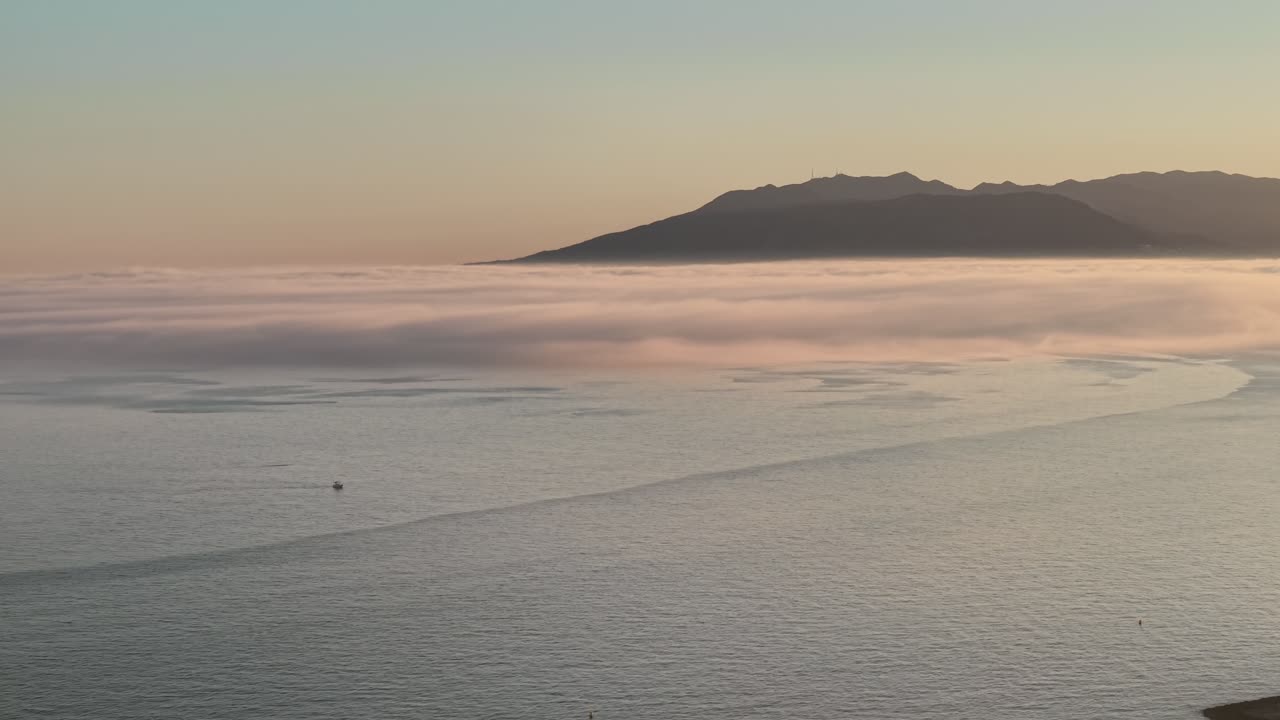 Calm ocean with misty morning view in Malaga, serene and peaceful vibe