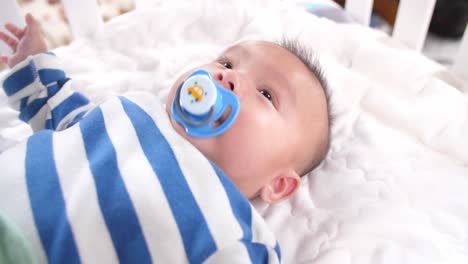 cute baby with a pacifier , video in 4k