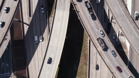 birdseye aerial view, traffic on complexed american highway junction interchange on sunny day