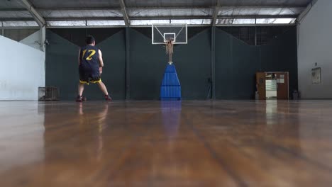 basketball player practicing dribble and shooting at indoors court. 4k uhd