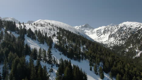 Drone-shot-of-snowy-peak-and-ski-slope-in-Malyovitsa-in-Bulgaria