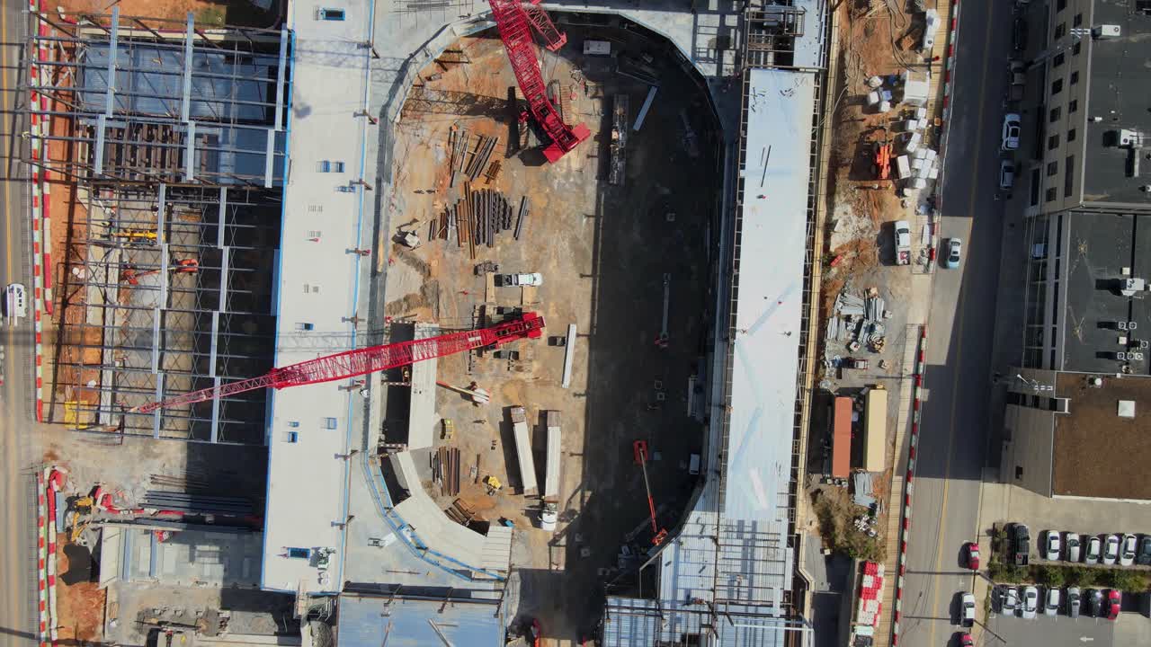 Red Construction Cranes Lifting Materials At The Development Site Of An Event Center In Clarksville, Tennessee