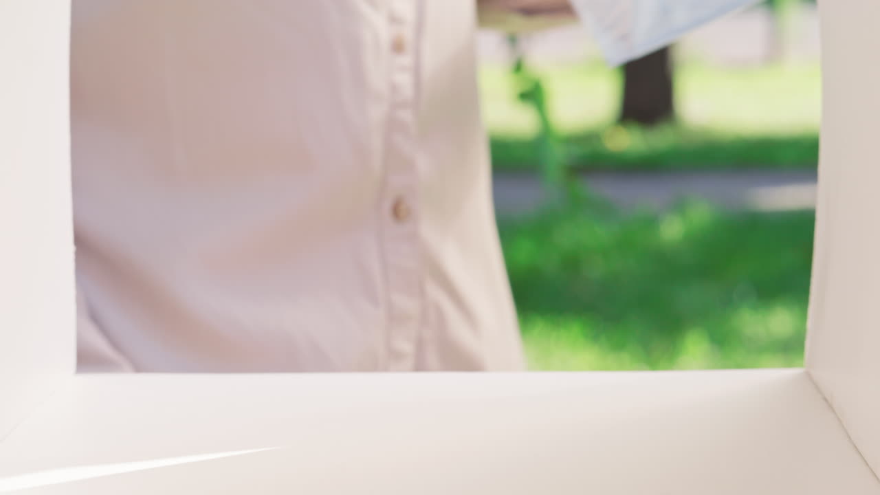 Hands of African American Woman Collecting Letters from Outdoor Mailbox