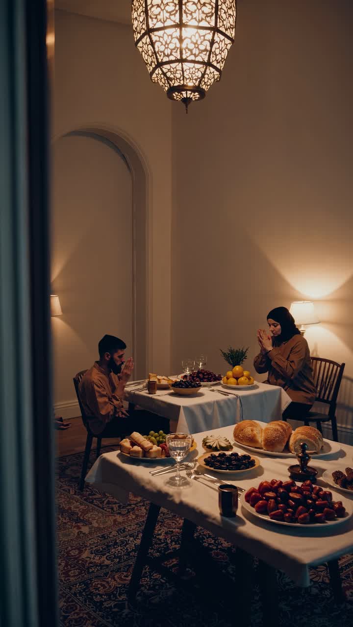 una pareja musulmana orando antes de la cena.