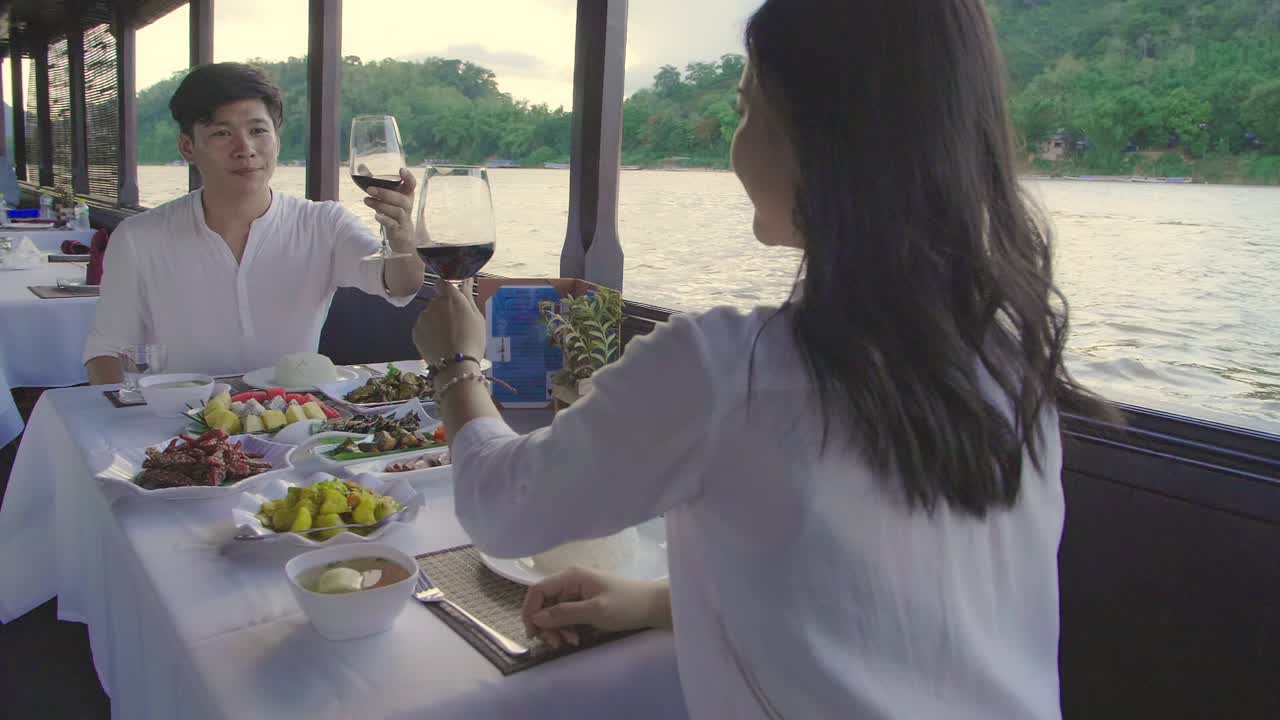Couple enjoying a romantic dinner cruise