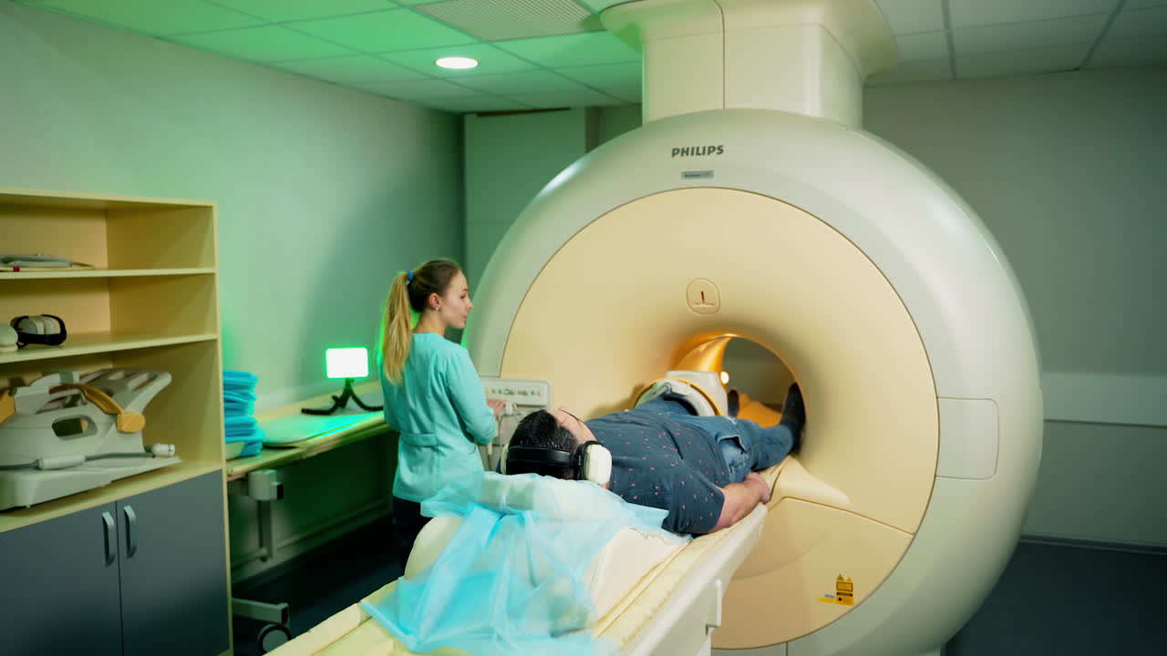 Male patient in mri machine. Medical laboratory worker controls MRI scanner. Doctor conducts emergency check up procedure.