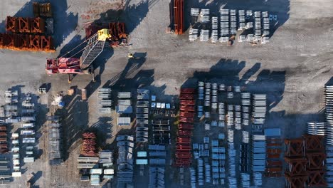 Top-down-aerial-of-crane-and-steel-products-made-in-USA-manufacturing-facility