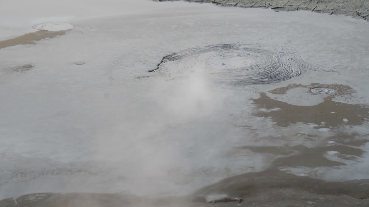 Vapore vulcanico che sale con pozze di fango geotermiche gorgoglianti in Islanda. Primo piano.