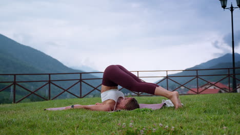 woman practicing yoga inversion pose in nature