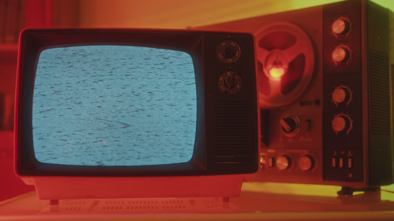 Old Analog TV with Static Noise and Reel-to-Reel Tape Recorder