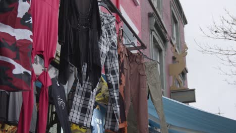 Close-Up-Of-Clothes-Hanging-Outside-Shops-On-Camden-High-Street-In-North-London-UK-2