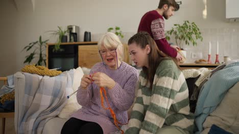 grandmother and granddaughter knitting together
