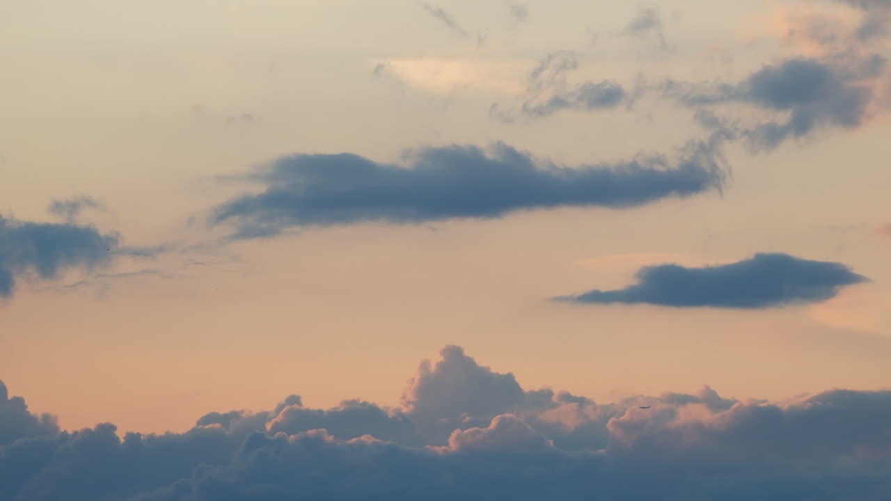time lapse of clouds lit by the setting sun