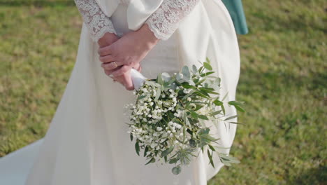 bride with bouquet and lace sleeve detail