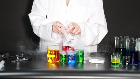 scientist conducting experiment with colorful liquids