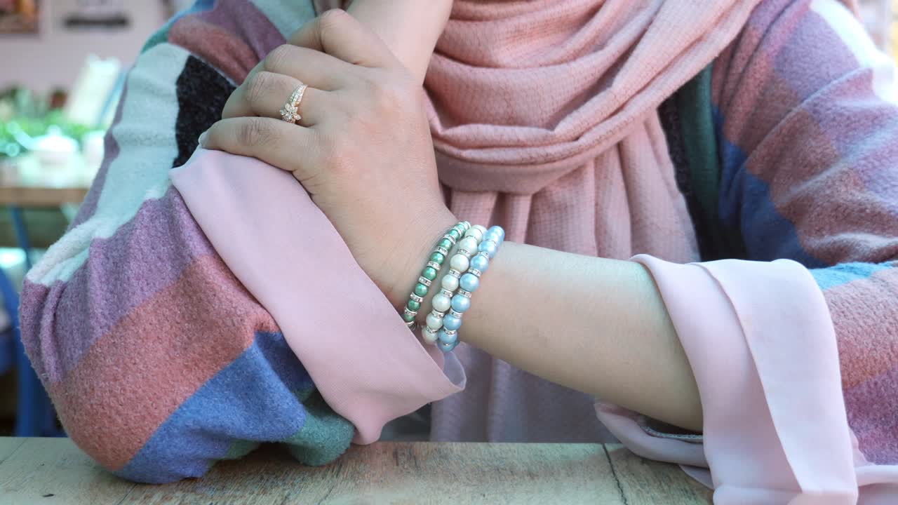 Woman wearing a hijab and bracelets