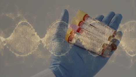 animation of dna strands over hand holding test tubes with blood