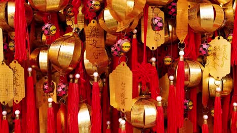 a close-up view of golden bells and red tassels, symbolizing wishes and blessings.