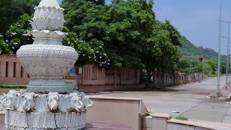 artistic white marble jain temple holy pillar with bright blue sky at morning from unique angle video is taken at shri digamber jain gyanoday tirth kshetra, nareli, ajmer, rajasthan, india