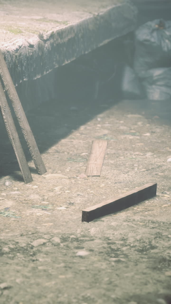 Mysterious wooden debris rests on a weathered shoreline at twilight