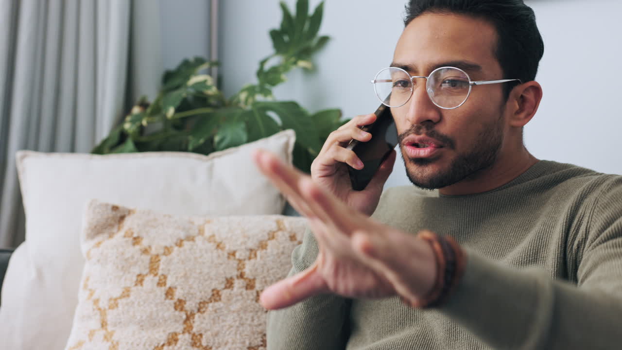 Angry client talking on a phone call while on sofa