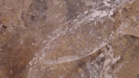 Flint-stone-surface-texture-macro-shot,-very-close-up-view-with-rotating-motion-studio-shot