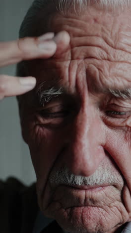 close-up portrait of an elderly man with closed eyes
