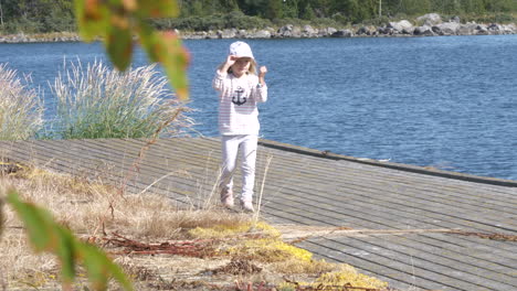 four year old girl walking on a pier in the stockholm archipelago