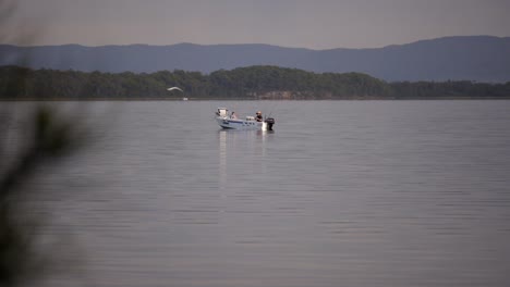 father and daughter fishing on lake, scenic day