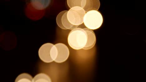 beautiful bokeh background on dark, out of focus lights during the night