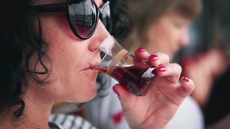 tourist drink turkish tea sitting on galata bridge on visit of istanbul, capital town of turkey