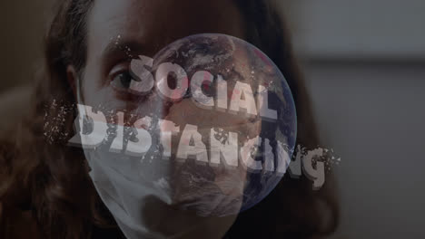 social distancing text over globe against woman wearing face mask