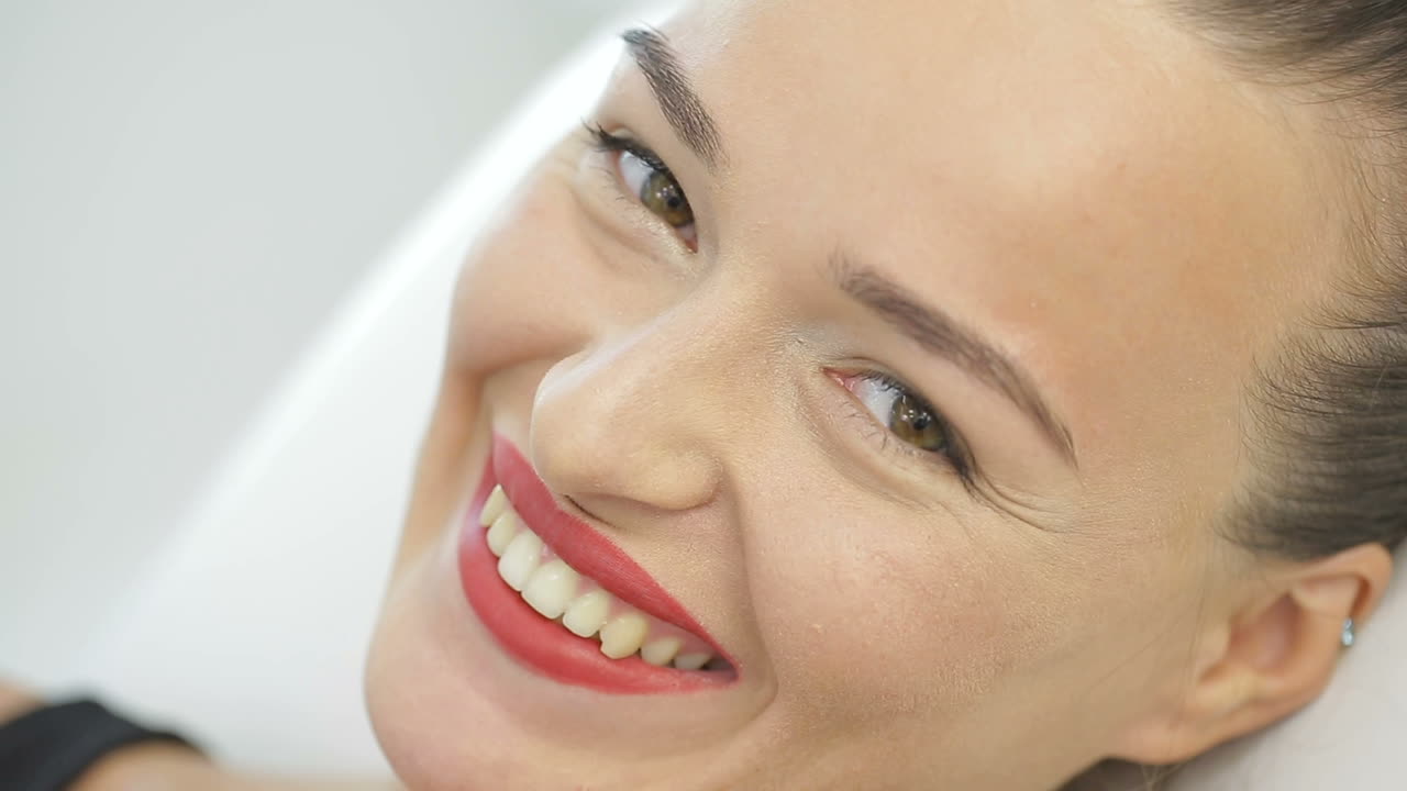 Girl Face With Makeup. Woman with permanent makeup looking at the camera