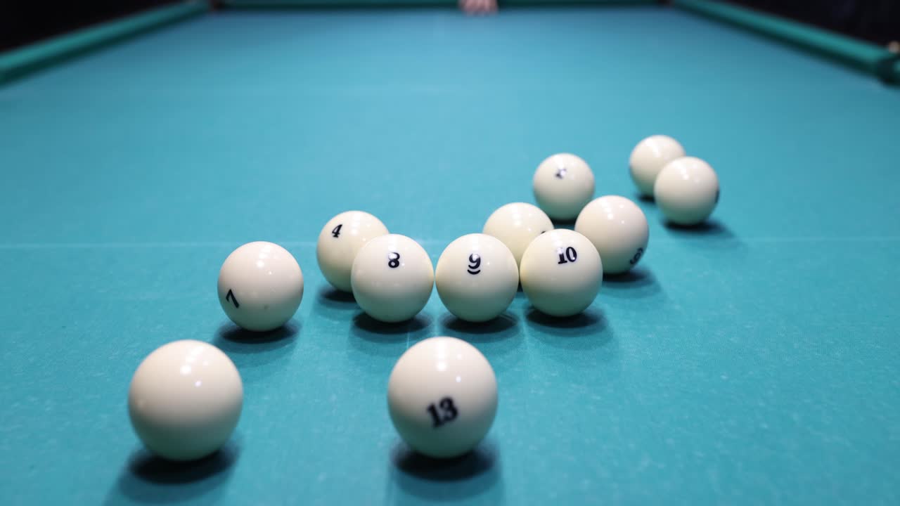 Player shooting ball to push goal into pocket of pool table