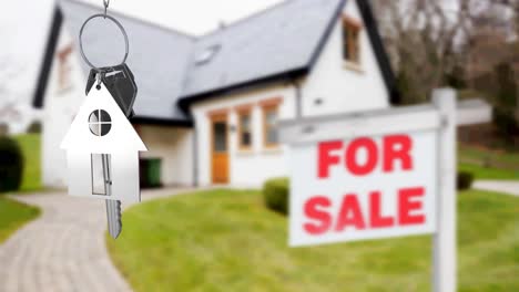 Animation-of-silver-house-key-fob-and-key,-hanging-in-front-of-blurred-house-with-for-sale-sign